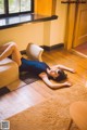 A woman laying on the floor in a living room.