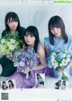 A group of young women sitting next to each other holding flowers.